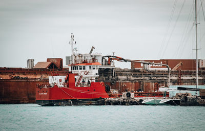 Boats moored at harbor