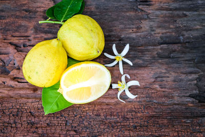 High angle view of fruits and leaves on table