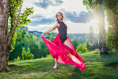 Portrait of young woman sitting on field