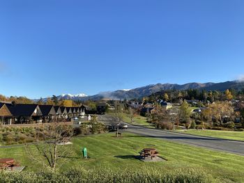 Scenic view of field against clear blue sky