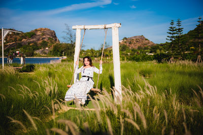 Woman on field against sky