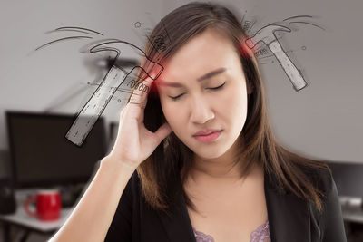 Digital composite image of hammer on head of woman suffering from headache