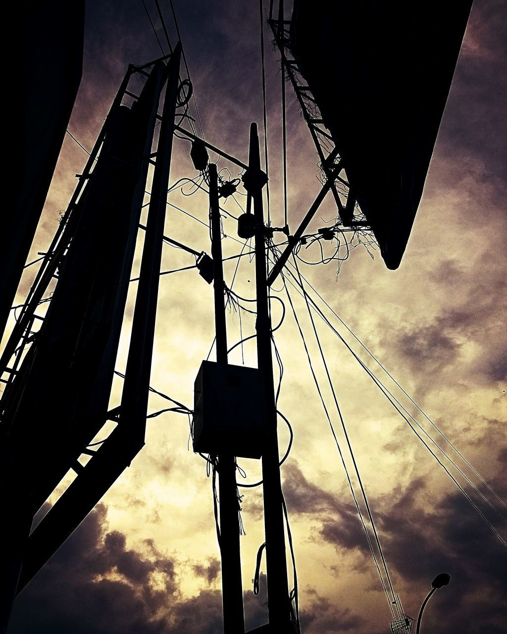 LOW ANGLE VIEW OF SILHOUETTE ELECTRICITY PYLONS AGAINST SKY