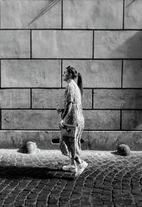 Rear view of woman sitting on steps