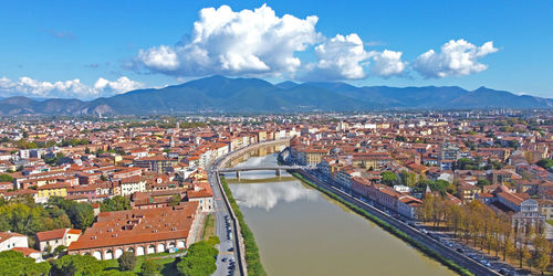 High angle view of river amidst buildings against sky