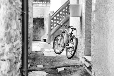 Bicycle leaning on wall of house