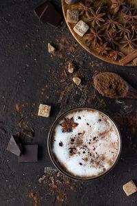 Hot chocolate or hot cocoa with anise star and cinnamon sticks.