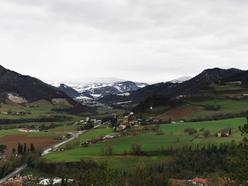 Scenic view of field and mountains against sky