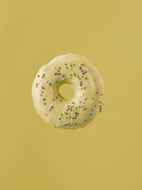Close-up of donut against yellow background
