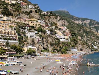 Scenic view of town by sea against clear sky