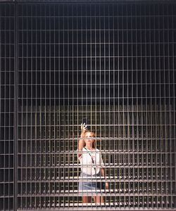 Woman standing in cage