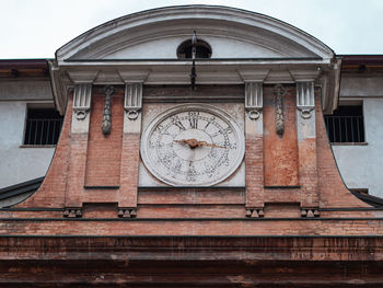 Low angle view of clock tower against building