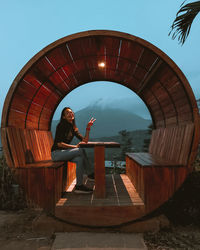 Full length of woman sitting at outdoor cafe