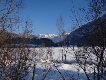 Scenic view of lake against clear sky during winter