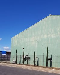 View of factory against clear blue sky