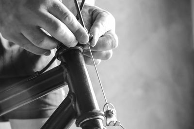 Close-up of hands repairing bicycle