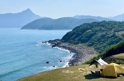 High angle view of sea and mountains against sky