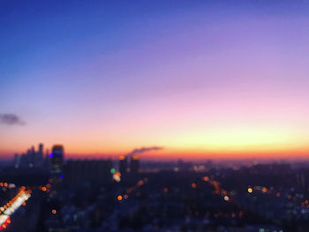 High angle view of illuminated buildings against sky during sunset