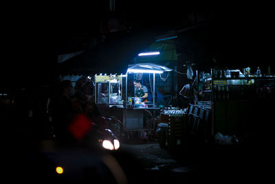 People in illuminated city at night