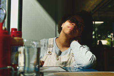 Thoughtful woman sitting in restaurant