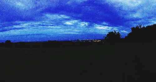 Silhouette of trees against sky at dusk