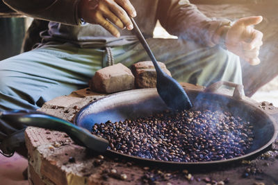 Midsection of man preparing food