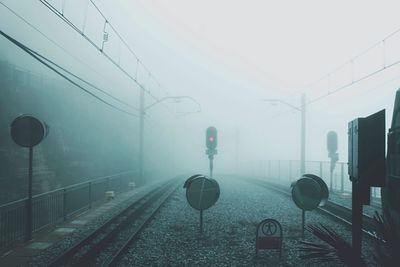 Railroad tracks against sky during foggy weather