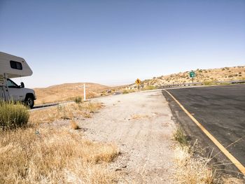 Road by landscape against clear sky