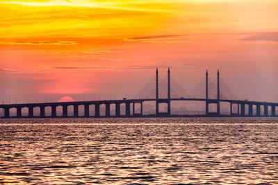 View of suspension bridge at sunset