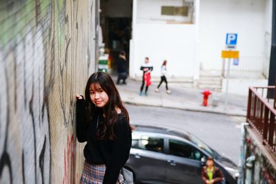 Portrait of woman standing in city