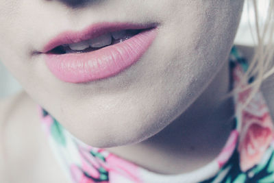 Cropped image of young woman with pink lipstick