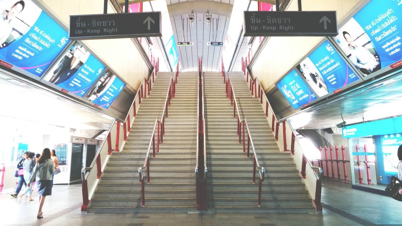 built structure, architecture, steps, steps and staircases, indoors, building exterior, text, low angle view, staircase, the way forward, modern, building, railing, ceiling, blue, western script, day, city, multi colored, city life