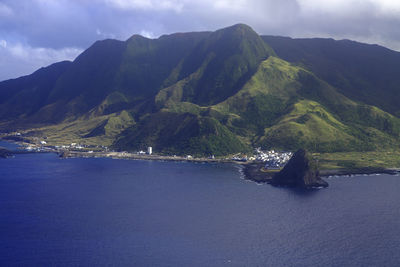 Scenic view of sea and mountains against sky