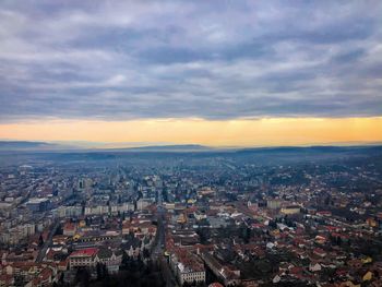 High angle shot of townscape against sky at sunset