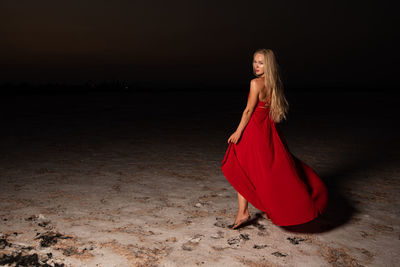 Side view of a young woman standing on beach