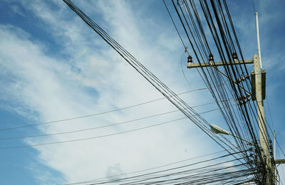 Low angle view of electricity pylon against sky