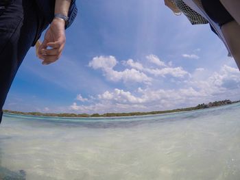 Midsection of man in sea against sky