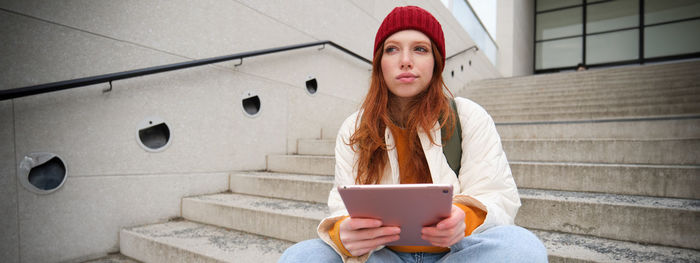 Portrait of young woman using mobile phone