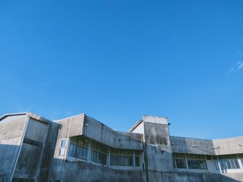 Low angle view of buildings against blue sky