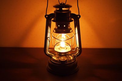 Close-up of illuminated lantern on table