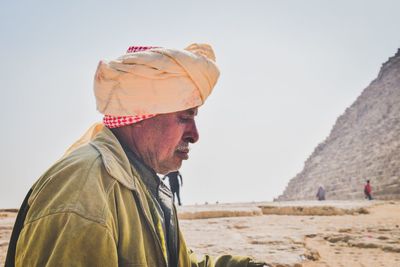 Side view of man standing against sky