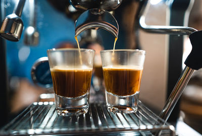 Close-up of coffee cups in glass