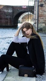 Portrait of young woman sitting outdoors