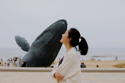 Rear view of woman standing against sky