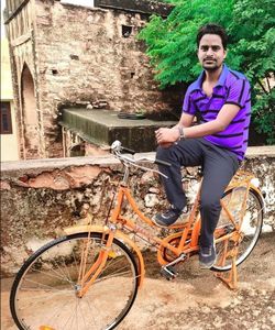 Portrait of young man riding bicycle