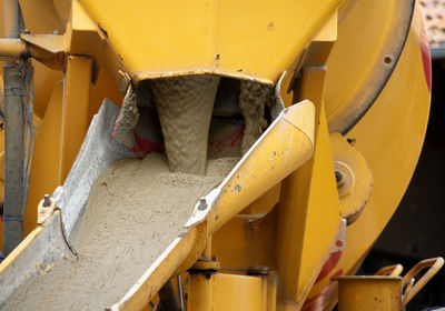 Liquid soil is poured from the ramp of concrete mixer