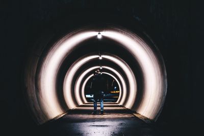 Rear view of man in tunnel