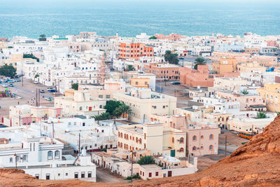 Residential and city buildings in sur, oman., golden hour, view from top.