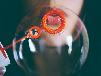 Close-up of woman blowing bubbles