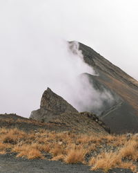 Mount meru partly covered by clouds, arusha national park, tanzania